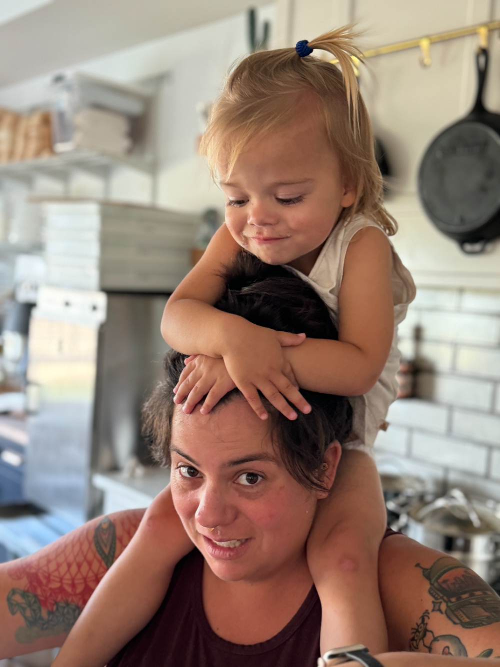 Lauren in the kitchen with her daughter on her shoulders